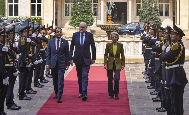 Lebanese caretaker Prime Minister Najib Mikati, center, welcomes Cyprus' President Nikos Christodoulides, left, and President of the European Commission Ursula von der Leyen at the government palace in Beirut, Lebanon, Thursday, May 2, 2024. (AP Photo/Hassan Ammar)