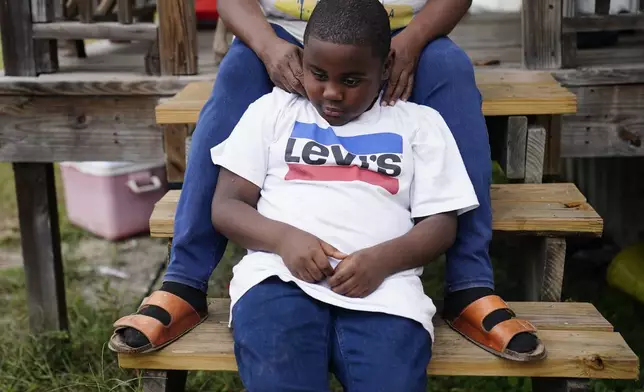 Yuri Brown, 7, sits with his mother, Bontressa Brown, for a portrait outside their home on Tuesday, Nov. 14, 2023, in Sylvester, Ga. Bontressa was seven months pregnant with Yuri when Terrell “Al” Clark died after an encounter with police in Sylvester. Clark was Yuri’s father. (AP Photo/Brynn Anderson)