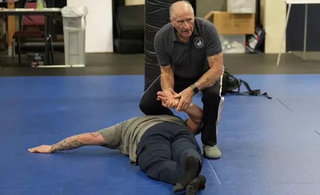 Instructor Dave Rose demonstrates a prone handcuffing position on a student during an Arrest &amp; Control Instructor course in Sacramento, Calif., on Thursday, Jan. 18, 2024. Rose has trained generations of officers that prone restraint is safe. His pupils are instructors who take his training back to their departments. (AP Photo/Rich Pedroncelli)