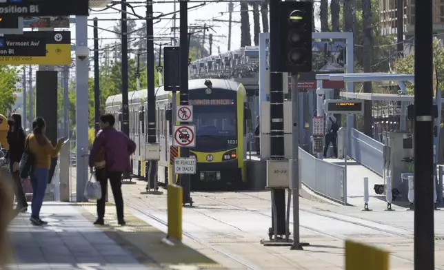 A Metro light rail train resumes service in Los Angeles, Tuesday, April 30, 2024. Officials say multiple people were hurt, and a few seriously, when a Metro light rail train and a University of Southern California shuttle bus collided in downtown Los Angeles. (AP Photo/Damian Dovarganes)