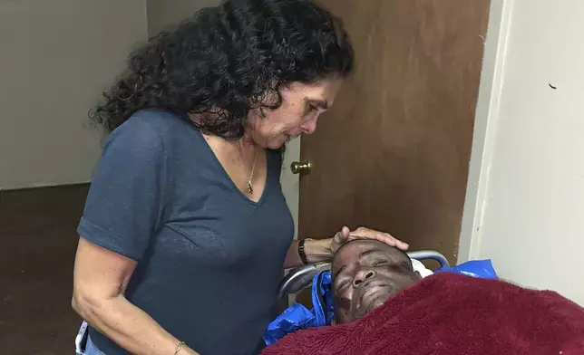 FILE - In this photo provided by Alana Wilson, Mona Hardin looks over the body of her son, Ronald Greene in Rayville, La., on May 13, 2019. Hardin has been waiting five long years for any resolution to the federal investigation into her son’s deadly arrest by Louisiana State Police troopers, an anguish only compounded by the fact that nearly every other major civil rights case during that time has passed her by. (Alana Wilson via AP, File)