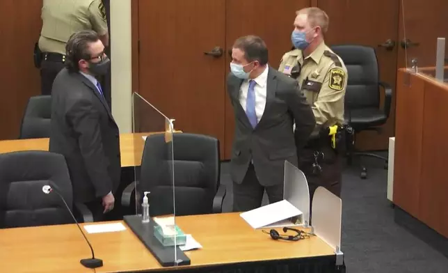 FILE - In this image from video, former Minneapolis police Officer Derek Chauvin, center, is taken into custody as his attorney, Eric Nelson, left, looks on, after the verdicts were read at Chauvin's trial for the 2020 death of George Floyd, Tuesday, April 20, 2021, at the Hennepin County Courthouse in Minneapolis, Minn. (Court TV via AP, Pool, File)