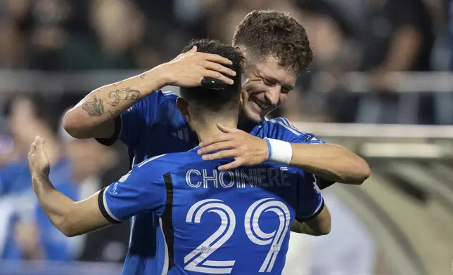 CF Montreal midfielder Mathieu Choiniere (29) is congratulated on his goal against the Columbus Crew by teammate Joaquin Sosa (3) during the first half of an MLS soccer game, Wednesday, May 15, 2024 in Montreal.(Christinne Muschi/The Canadian Press via AP)