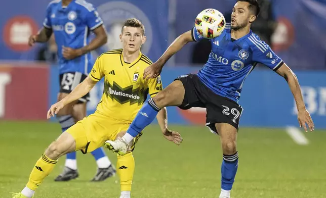 CF Montreal midfielder Mathieu Choiniere (29) and Columbus Crew midfielder Sean Zawadzki (25) battle during the second half of an MLS soccer game, Wednesday, May 15, 2024 in Montreal.(Christinne Muschi/The Canadian Press via AP)