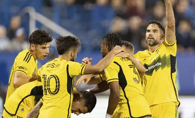 Columbus Crew forward Diego Rossi (10) celebrates his goal over CF Montreal with teammates during the second half of an MLS soccer game, Wednesday, May 15, 2024 in Montreal.(Christinne Muschi/The Canadian Press via AP)