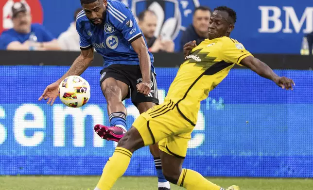 CF Montreal defender Ruan (22) advances the ball against Columbus Crew midfielder Yaw Yeboah (14) during the first half of an MLS soccer game, Wednesday, May 15, 2024 in Montreal.(Christinne Muschi/The Canadian Press via AP)