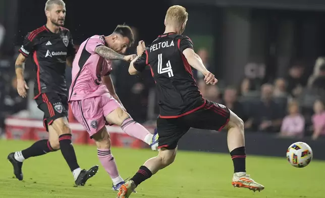 Inter Miami forward Lionel Messi, center attempts a shot on the goal past D.C. United midfielder Matti Peltola (4) during the second half of an MLS soccer match, Saturday, May 18, 2024, in Fort Lauderdale, Fla. (AP Photo/Lynne Sladky)