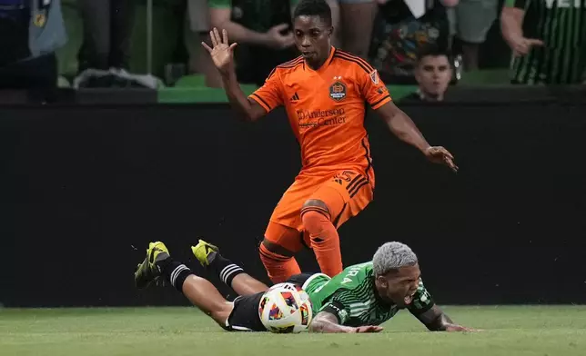 Austin FC midfielder Daniel Pereira, bottom, is tripped up by Austin FC defender Leo Vaisanen (15) during the second half of an MLS soccer match, Wednesday, May 15, 2024, in Austin, Texas. (AP Photo/Eric Gay)
