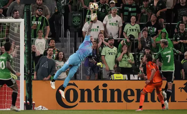 Houston Dynamo goalkeeper Steve Clark, center, lunges to block a shot during the second half of an MLS soccer match against Austin FC, Wednesday, May 15, 2024, in Austin, Texas. (AP Photo/Eric Gay)