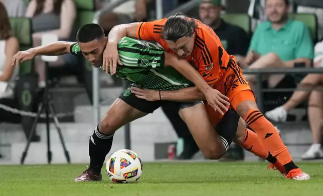 Austin FC midfielder Owen Wolff, left, and Houston Dynamo forward Tate Schmitt , right, compete for control of the ball during the second half of an MLS soccer match, Wednesday, May 15, 2024, in Austin, Texas. (AP Photo/Eric Gay)
