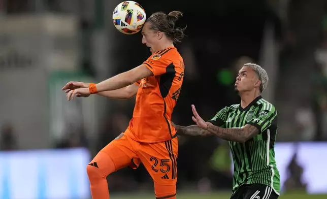Houston Dynamo midfielder Griffin Dorsey (25) heads the ball past Austin FC midfielder Daniel Pereira (6) during the second half of an MLS soccer match, Wednesday, May 15, 2024, in Austin, Texas. (AP Photo/Eric Gay)