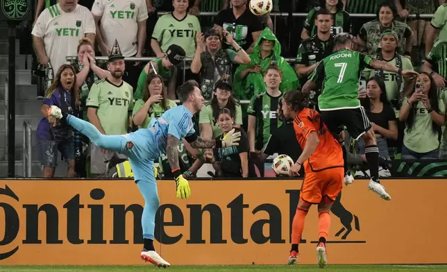Houston Dynamo goalkeeper Steve Clark, left, lunges to block a shot during the second half of an MLS soccer match against Austin FC, Wednesday, May 15, 2024, in Austin, Texas. (AP Photo/Eric Gay)
