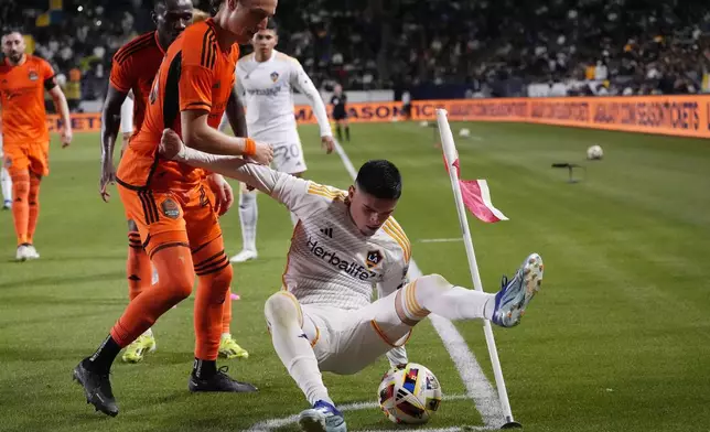 Los Angeles Galaxy forward Gabriel Pec, right, battles with Houston Dynamo midfielder Griffin Dorsey during the second half of a Major League Soccer match Saturday, May 25, 2024, in Carson, Calif. (AP Photo/Mark J. Terrill)