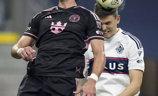 Vancouver Whitecaps' Ranko Veselinovic, right, and Inter Miami's Leonardo Campana vie for the ball during the second half of an MLS soccer match Saturday, May 25, 2024, in Vancouver, British Columbia. (Darryl Dyck/The Canadian Press via AP)
