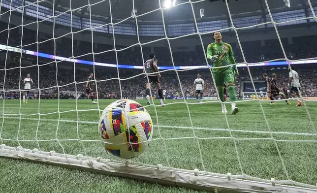 Vancouver Whitecaps goalkeeper Yohei Takaoka, front right, looks at the ball in the back of the net after allowing a goal to Inter Miami's Robert Taylor during the first half of an MLS soccer match Saturday, May 25, 2024, in Vancouver, British Columbia. (Darryl Dyck/The Canadian Press via AP)