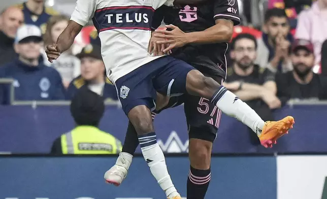 Vancouver Whitecaps' Fafa Picault, left, and Inter Miami's Marcelo Weigandt vie for the ball during the first half of an MLS soccer match Saturday, May 25, 2024, in Vancouver, British Columbia. (Darryl Dyck/The Canadian Press via AP)