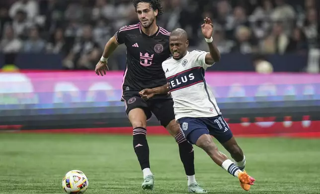 Vancouver Whitecaps' Fafa Picault, right, and Inter Miami's Leonardo Campana vie for the ball during the second half of an MLS soccer match Saturday, May 25, 2024, in Vancouver, British Columbia. (Darryl Dyck/The Canadian Press via AP)