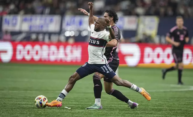 Vancouver Whitecaps' Fafa Picault, front, and Inter Miami's Leonardo Campana vie for the ball during the second half of an MLS soccer match Saturday, May 25, 2024, in Vancouver, British Columbia. (Darryl Dyck/The Canadian Press via AP)