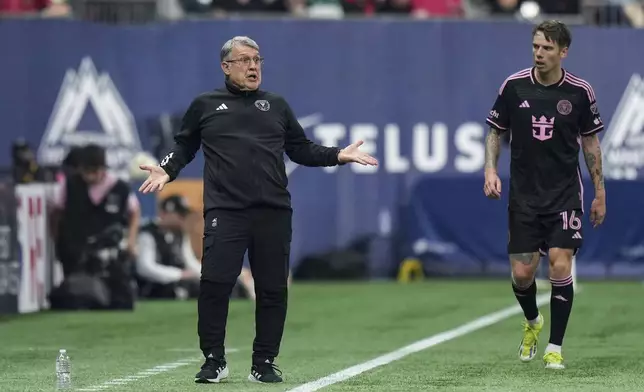 Inter Miami coach Tata Martino, left, reacts on the sideline as Robert Taylor watches during the second half of the team's MLS soccer match against the Vancouver Whitecaps on Saturday, May 25, 2024, in Vancouver, British Columbia. (Darryl Dyck/The Canadian Press via AP)