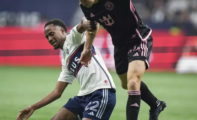 Inter Miami's Julian Gressel, right, and Vancouver Whitecaps' Ali Ahmed vie for the ball during the second half of an MLS soccer match Saturday, May 25, 2024, in Vancouver, British Columbia. (Darryl Dyck/The Canadian Press via AP)