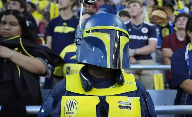 A Nashville SC fan wears a Boba Fett themed costume for Star Wars Night during an MLS soccer match between Nashville SC and CF Montréal, Saturday, May 4, 2024, in Nashville, Tenn. (AP Photo/George Walker IV)
