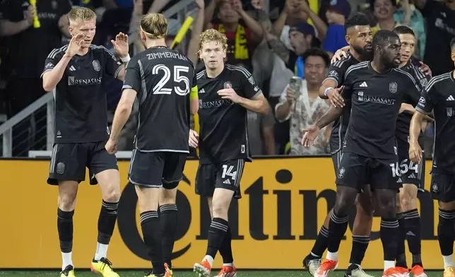 Nashville SC forward Sam Surridge, far left, is congratulated by teammates after his goal against CF Montréal during the first half of an MLS playoff soccer match Saturday, May 4, 2024, in Nashville, Tenn. (AP Photo/George Walker IV)