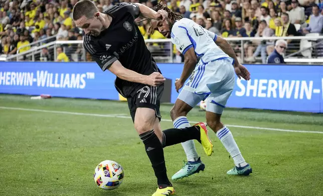 Nashville SC midfielder Alex Muyl (19) takes the ball from CF Montréal forward Raheem Edwards (44) during the first half of an MLS playoff soccer match Saturday, May 4, 2024, in Nashville, Tenn. (AP Photo/George Walker IV)