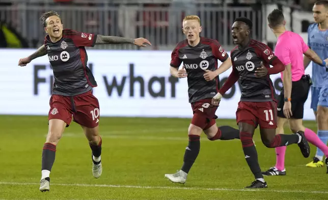 Toronto FC forward Federico Bernardeschi (10) celebrates his goal against NYC FC with midfielder Matty Longstaff (8) and forward Latif Blessing (11) during the second half of an MLS soccer match Saturday, May 11, 2024, in Toronto. (Frank Gunn/The Canadian Press via AP)