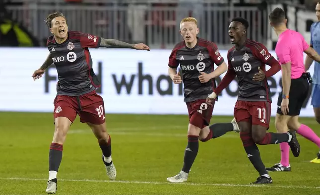 Toronto FC forward Federico Bernardeschi (10) celebrates his goals against NYC FC with midfielder Matty Longstaff (8) and forward Latif Blessing (11) during the second half of an MLS soccer match Saturday, May 11, 2024, in Toronto. (Frank Gunn/The Canadian Press via AP)z