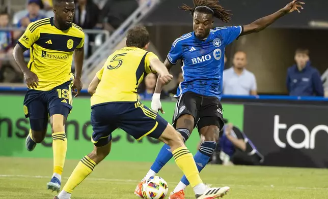 CF Montreal's Jules-Anthony Vilsaint, right, shoots as Nashville SC's Jack Maher (5) defends during the first half of an MLS soccer match Saturday, May 25, 2024, in Montreal. (Peter McCabe/The Canadian Press via AP)