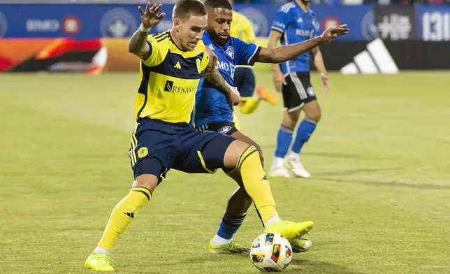 CF Montreal's Ruan works against Nashville SC's Tyler Boyd, left, during the first half of an MLS soccer match Saturday, May 25, 2024, in Montreal. (Peter McCabe/The Canadian Press via AP)