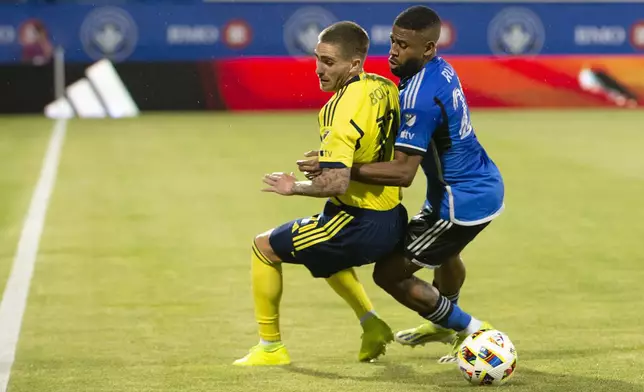 CF Montreal's Ruan, right, battles Nashville SC's Tyler Boyd, left, during first-half MLS soccer match action in Montreal, Saturday, May 25, 2024. (Peter McCabe/The Canadian Press via AP)