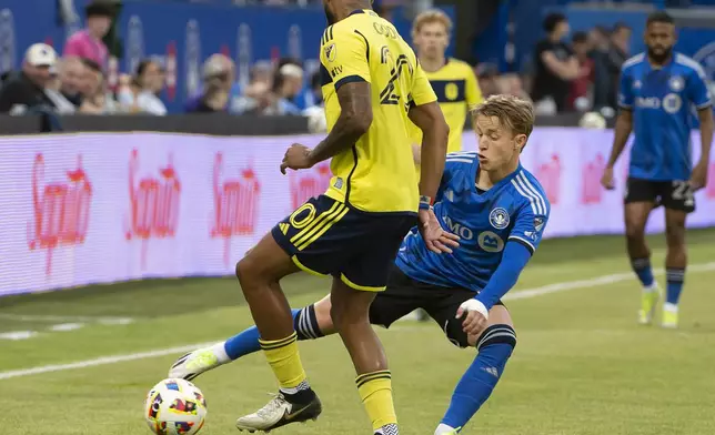 CF Montreal's Bryce Duke, right, reaches in to steal the ball from Nashville SC's Anibal Godoy during the first half of an MLS soccer match Saturday, May 25, 2024, in Montreal. (Peter McCabe/The Canadian Press via AP)
