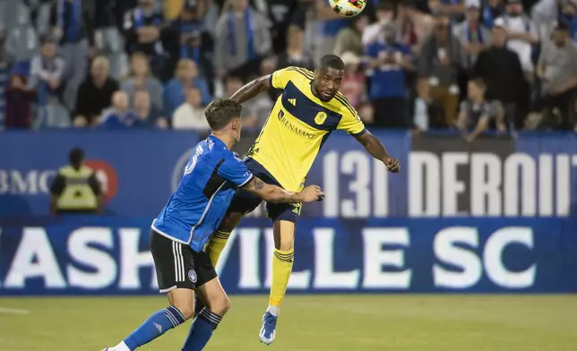 Nashville SC's Shaq Moore heads the ball to clear it away from CF Montreal's Joaquin Sosa during the second half of an MLS soccer match Saturday, May 25, 2024, in Montreal. (Peter McCabe/The Canadian Press via AP)