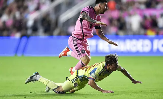 Inter Miami forward Lionel Messi runs into New York Red Bulls midfielder Daniel Edelman during the first half of an MLS soccer match Saturday, May 4, 2024, in Fort Lauderdale, Fla. (AP Photo/Michael Laughlin)