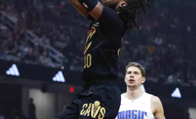 Cleveland Cavaliers guard Darius Garland (10) shoots against Orlando Magic center Moritz Wagner (21) during the first half of Game 5 of an NBA basketball first-round playoff series, Tuesday, April 30, 2024, in Cleveland. (AP Photo/Ron Schwane)