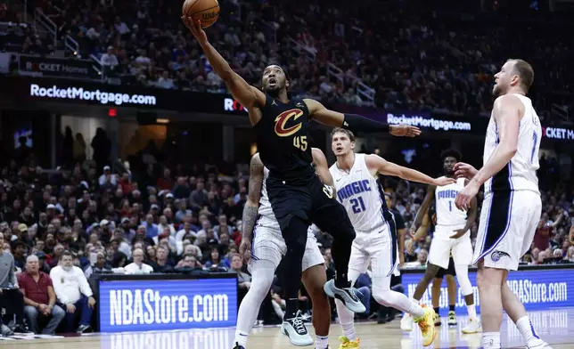 Cleveland Cavaliers guard Donovan Mitchell (45) shoots against the Orlando Magic during the first half of Game 5 of an NBA basketball first-round playoff series, Tuesday, April 30, 2024, in Cleveland. (AP Photo/Ron Schwane)