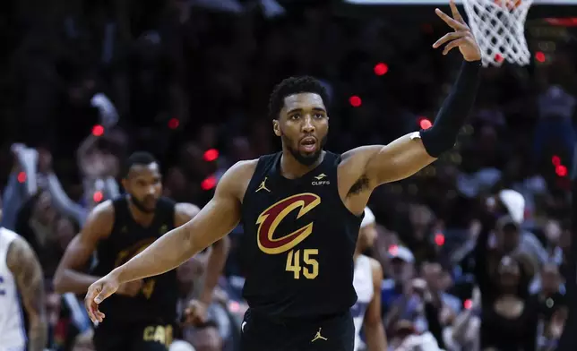 Cleveland Cavaliers guard Donovan Mitchell celebrates after making a three point basket against the Orlando Magic during the second half of Game 5 of an NBA basketball first-round playoff series, Tuesday, April 30, 2024, in Cleveland. (AP Photo/Ron Schwane)