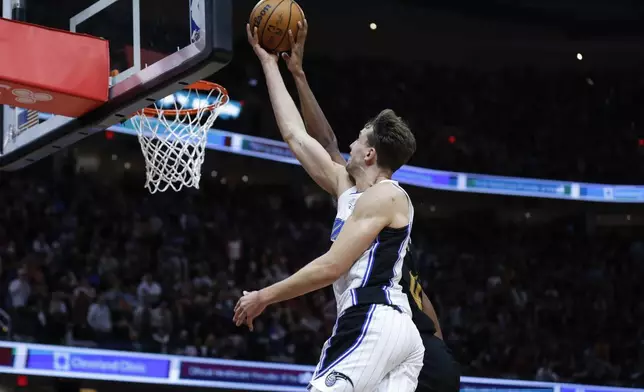 Cleveland Cavaliers forward Evan Mobley blocks a shot by Orlando Magic forward Franz Wagner during the second half of Game 5 of an NBA basketball first-round playoff series, Tuesday, April 30, 2024, in Cleveland. (AP Photo/Ron Schwane)