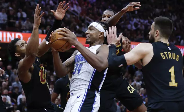 Orlando Magic center Wendell Carter Jr. (34) rebounds against the Cleveland Cavaliers during the second half of Game 5 of an NBA basketball first-round playoff series, Tuesday, April 30, 2024, in Cleveland. (AP Photo/Ron Schwane)
