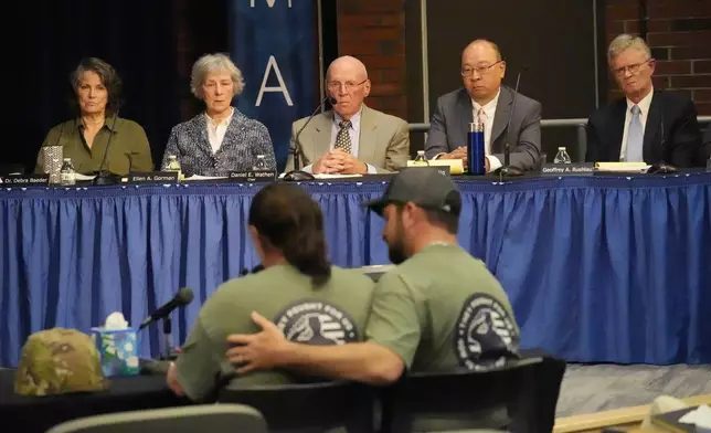 Members of the independent commission investigating the law enforcement response to the mass shooting in Lewiston, Maine, listen as Nicole Herling, sister of shooter Robert Card, testifies, Thursday, May 16, 2024, in Augusta, Maine. (AP Photo/Robert F. Bukaty)