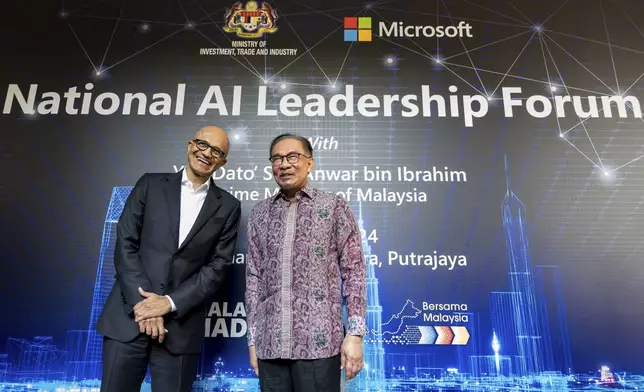 In this photo provided by Malaysia Prime Minister Office, Malaysia's Prime Minister Anwar Ibrahim, right, poses for a photo with Microsoft CEO Satya Nadella in Putrajaya, Malaysia, Thursday, May 2, 2024. (Albarra Azfar/Prime Minister's Office of Malaysia via AP)