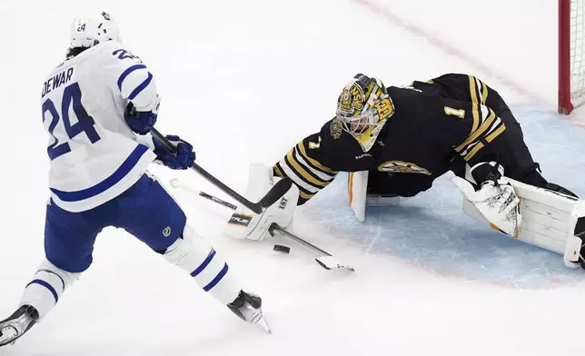 Boston Bruins' Jeremy Swayman (1) blocks a shot by Toronto Maple Leafs' Connor Dewar (24) during the second period of Game 7 of an NHL hockey Stanley Cup first-round playoff series, Saturday, May 4, 2024, in Boston. (AP Photo/Michael Dwyer)