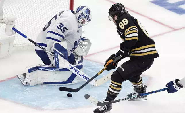 Boston Bruins' David Pastrnak (88) sets up to score on Toronto Maple Leafs' Ilya Samsonov (35) in overtime during Game 7 of an NHL hockey Stanley Cup first-round playoff series, Saturday, May 4, 2024, in Boston. (AP Photo/Michael Dwyer)