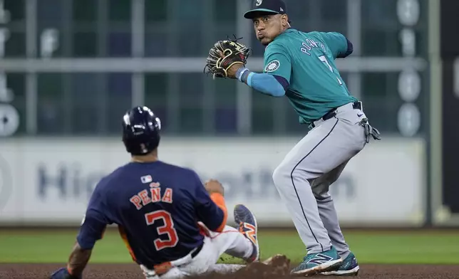 Seattle Mariners second baseman Jorge Polanco, right, turns a double play on Houston Astros' Yainer Diaz after forcing out Jeremy Peña (3) during the seventh inning of a baseball game Saturday, May 4, 2024, in Houston. (AP Photo/Kevin M. Cox)