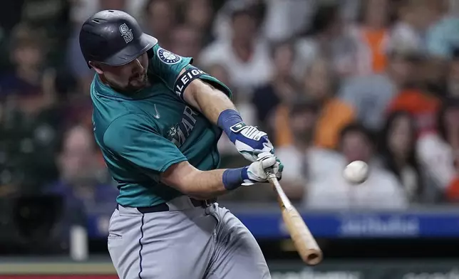 Seattle Mariners' Cal Raleigh hits a two-run home run during the sixth inning of a baseball game against the Houston Astros Saturday, May 4, 2024, in Houston. (AP Photo/Kevin M. Cox)