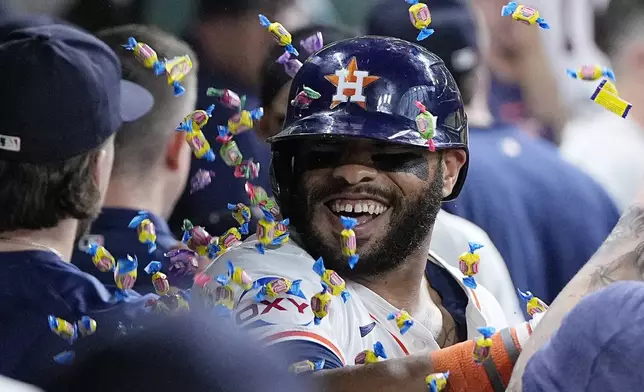 Houston Astros' Jon Singleton is congratulated in the dugout after hitting a go-ahead two-run home run during the seventh inning of a baseball game against the Seattle Mariners, Sunday, May 5, 2024, in Houston. (AP Photo/Kevin M. Cox)