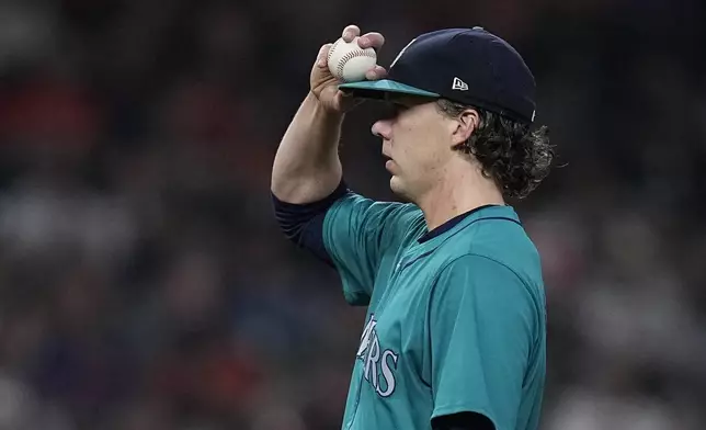 Seattle Mariners starting pitcher Logan Gilbert adjusts his cap during the eighth inning of a baseball game against the Houston Astros, Saturday, May 4, 2024, in Houston. (AP Photo/Kevin M. Cox)