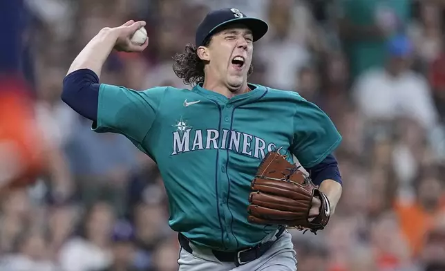 Seattle Mariners starting pitcher Logan Gilbert fields an infield hit by Houston Astros' Yordan Alvarez during the first inning of a baseball game Saturday, May 4, 2024, in Houston. (AP Photo/Kevin M. Cox)