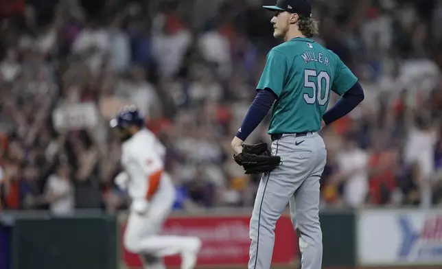 Seattle Mariners starting pitcher Bryce Miller waits for Houston Astros' Jon Singleton to run the bases after hitting a go-ahead two-run home run during the seventh inning of a baseball game, Sunday, May 5, 2024, in Houston. (AP Photo/Kevin M. Cox)